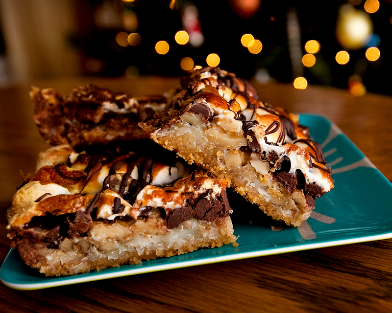 The most insane rocky road bars ever!  A crunchy graham cracker crust layered with walnuts, marshmallows, coconut, sweetened condensed milk, toasted marshmallows and a chocolate drizzle.