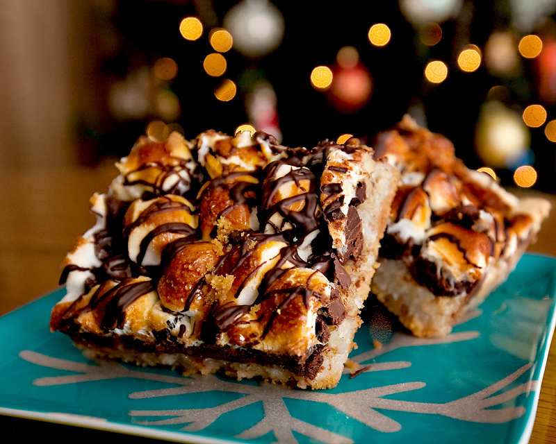 The most insane rocky road bars ever!  A crunchy graham cracker crust layered with walnuts, marshmallows, coconut, sweetened condensed milk, toasted marshmallows and a chocolate drizzle.