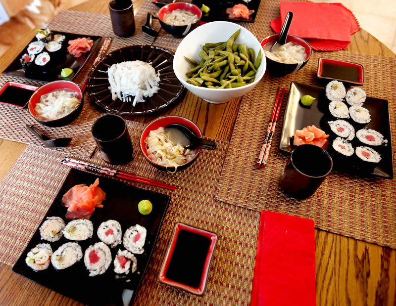 Homemade sushi spread on table.