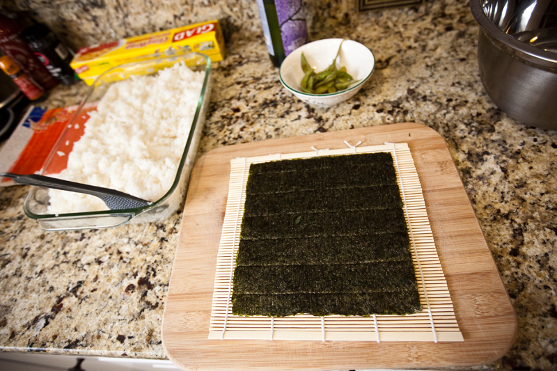 Sushi rice and Nori on bamboo sheet.