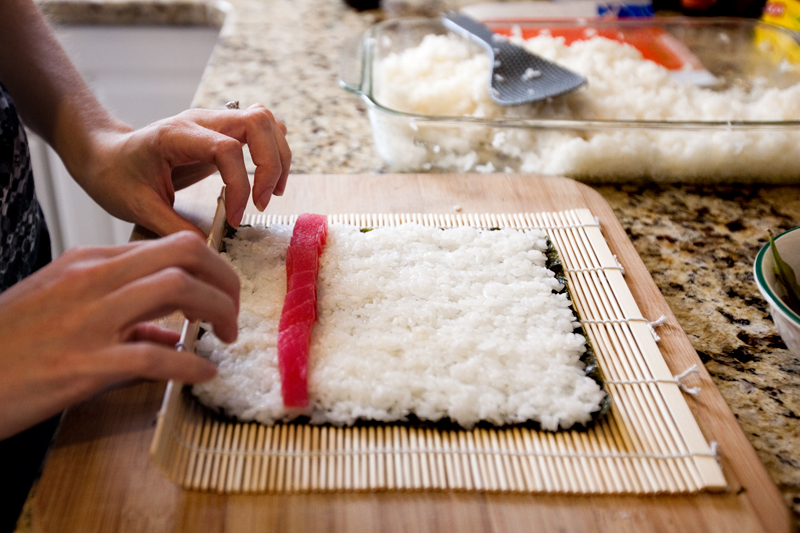 Rolling a homemade tuna roll