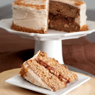 Caramel apple spice cake with caramel cream cheese frosting, garnished with crushed Speculoos cookies!