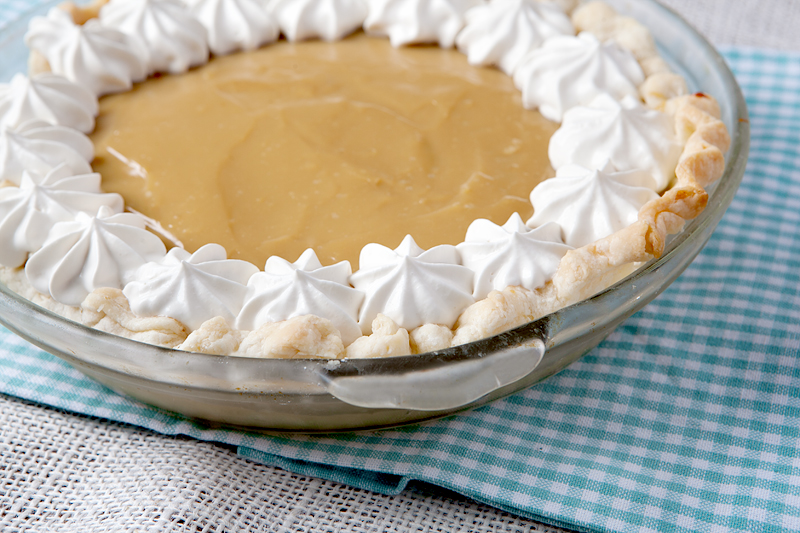 Silky smooth butterscotch pie topped with whipped cream made with Bailey's Irish Cream.