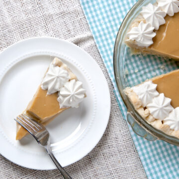 Silky smooth butterscotch pie topped with whipped cream made with Bailey's Irish Cream.