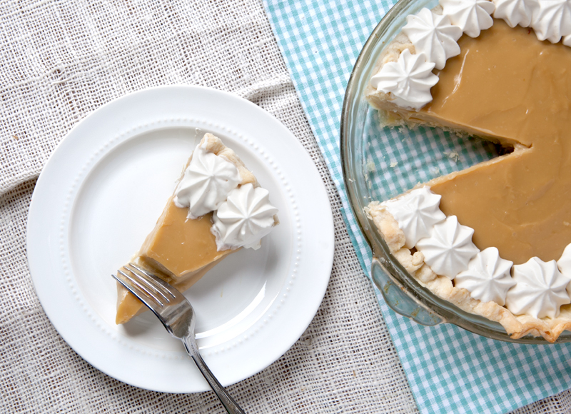 Silky smooth butterscotch pie topped with whipped cream made with Bailey's Irish Cream.