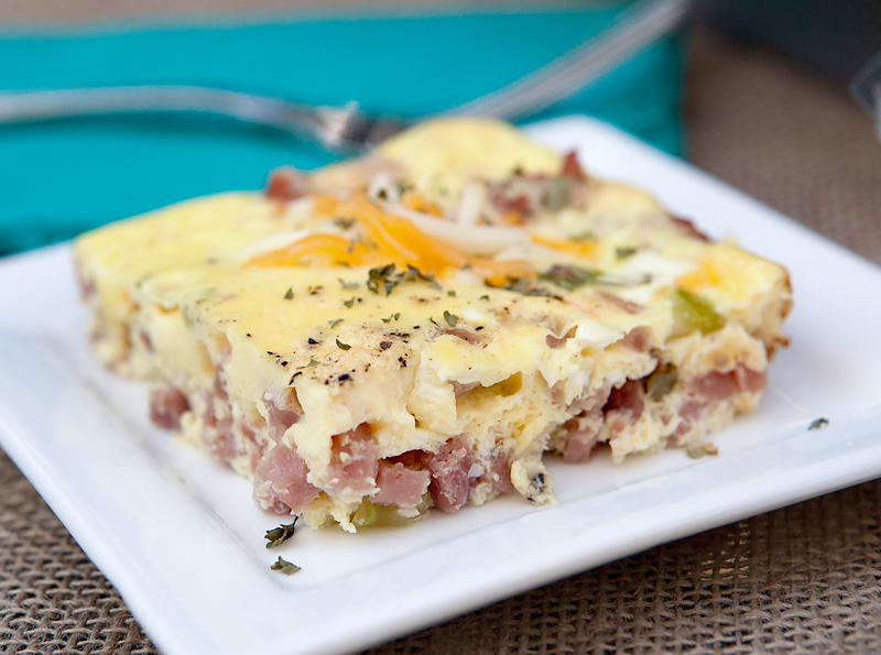 Easy baked breakfast omelet - full of flavorful onions and peppers, cheese, and ham! Fast breakfast idea! 