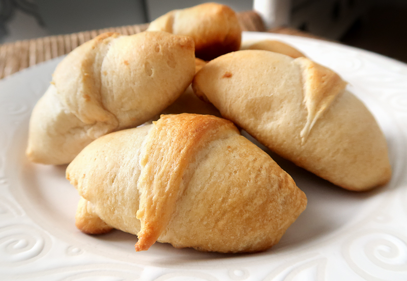 Perfect party food idea or appetizer! Crescent rolls stuffed with shredded chicken mixed with a homemade Thai peanut sauce.