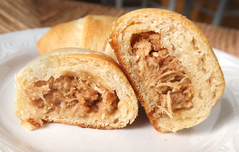 Perfect party food idea or appetizer! Crescent rolls stuffed with shredded chicken mixed with a homemade Thai peanut sauce.