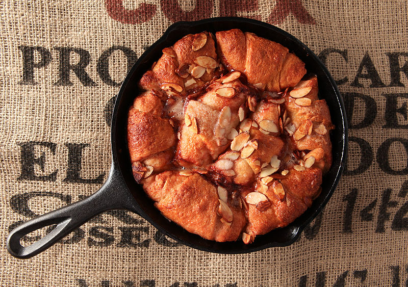 Hot crescent dumplings filled with cherries and covered in a sweet cola glaze and sliced almonds.