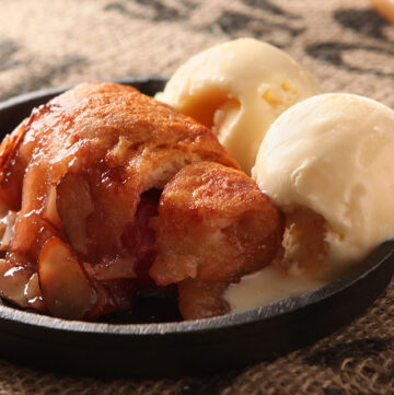 Hot crescent dumplings filled with cherries and covered in a sweet cola glaze and sliced almonds.