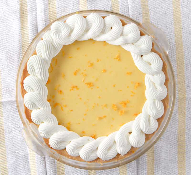 Smooth orange creamsicle pie with the best homemade ginger whipped cream EVER!  Omg so good!