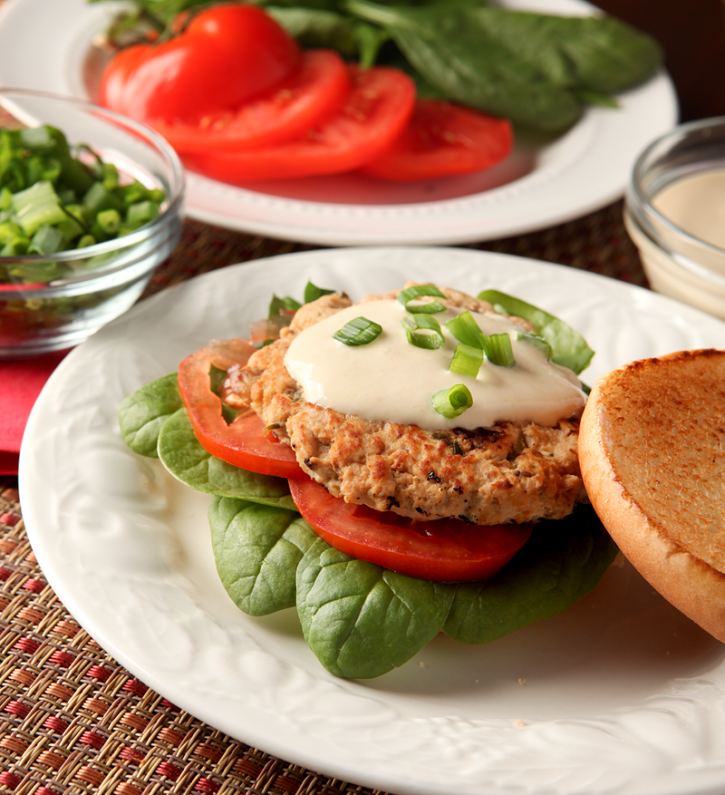 Turkey burgers don't have to be boring! These are loaded with flavors like orange juice and soy and are spread with a low calorie Greek yogurt aioli. 