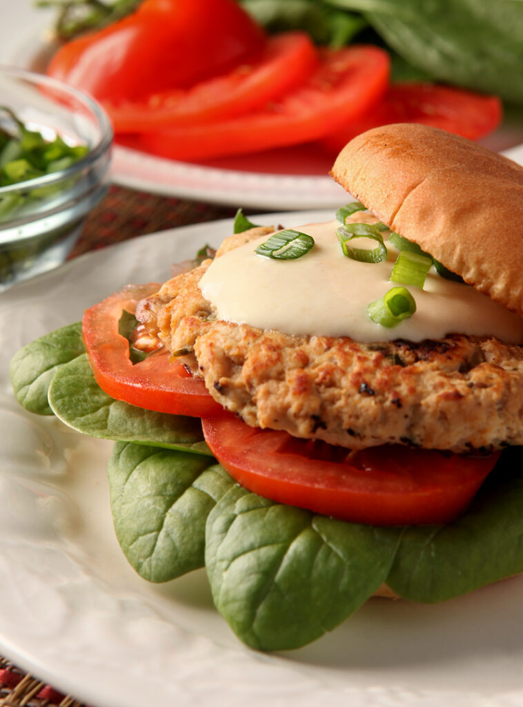 Turkey burgers don't have to be boring! These are loaded with flavors like orange juice and soy and are spread with a low calorie Greek yogurt aioli. 