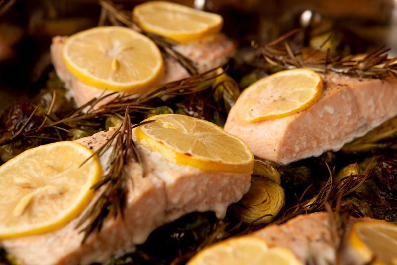 Delicious lemon herb roasted salmon with fresh rosemary and lemon slices