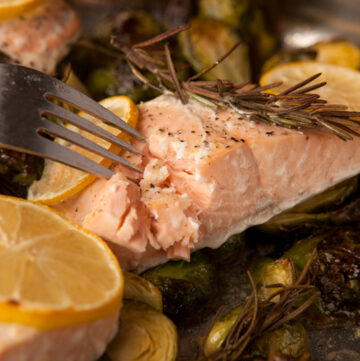 Delicious lemon herb roasted salmon with fresh rosemary and lemon slices