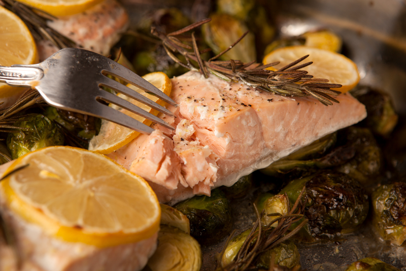 Delicious lemon herb roasted salmon with fresh rosemary and lemon slices