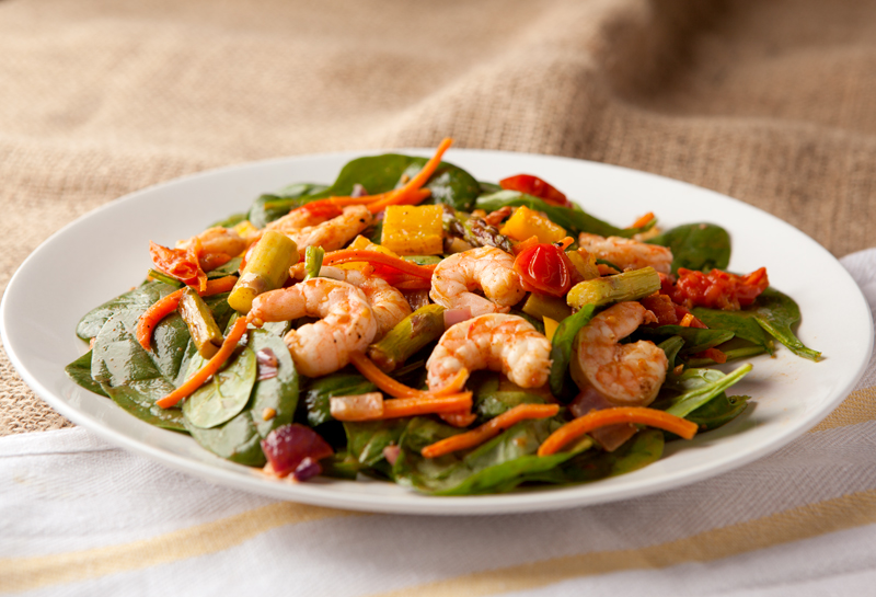 Roasted seasoned vegetables and shrimp tossed with baby spinach and a homemade chili vinaigrette dressing. Delicious low carb salad idea!