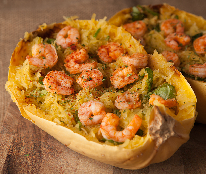 Fantastic low carb dinner idea!  Roasted spaghetti squash is mixed with pesto, parmesan, garlic, and spinach and  served with flavorful sauteed shrimp!
