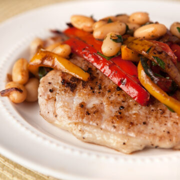 These pork cutlets with sauteed bell peppers and white beans and an easy dinner idea! Low carb and incredibly simple.