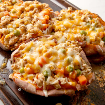 Baked sweet potato stuffed with a Shepherd's Pie filling - cheesy, easy dinner idea that's a riff on a classic favorite.