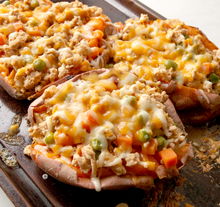 Baked sweet potato stuffed with a Shepherd's Pie filling - cheesy, easy dinner idea that's a riff on a classic favorite.