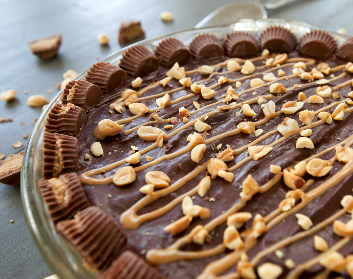 close up of chocolate peanut butter pie with reese's cup decorations