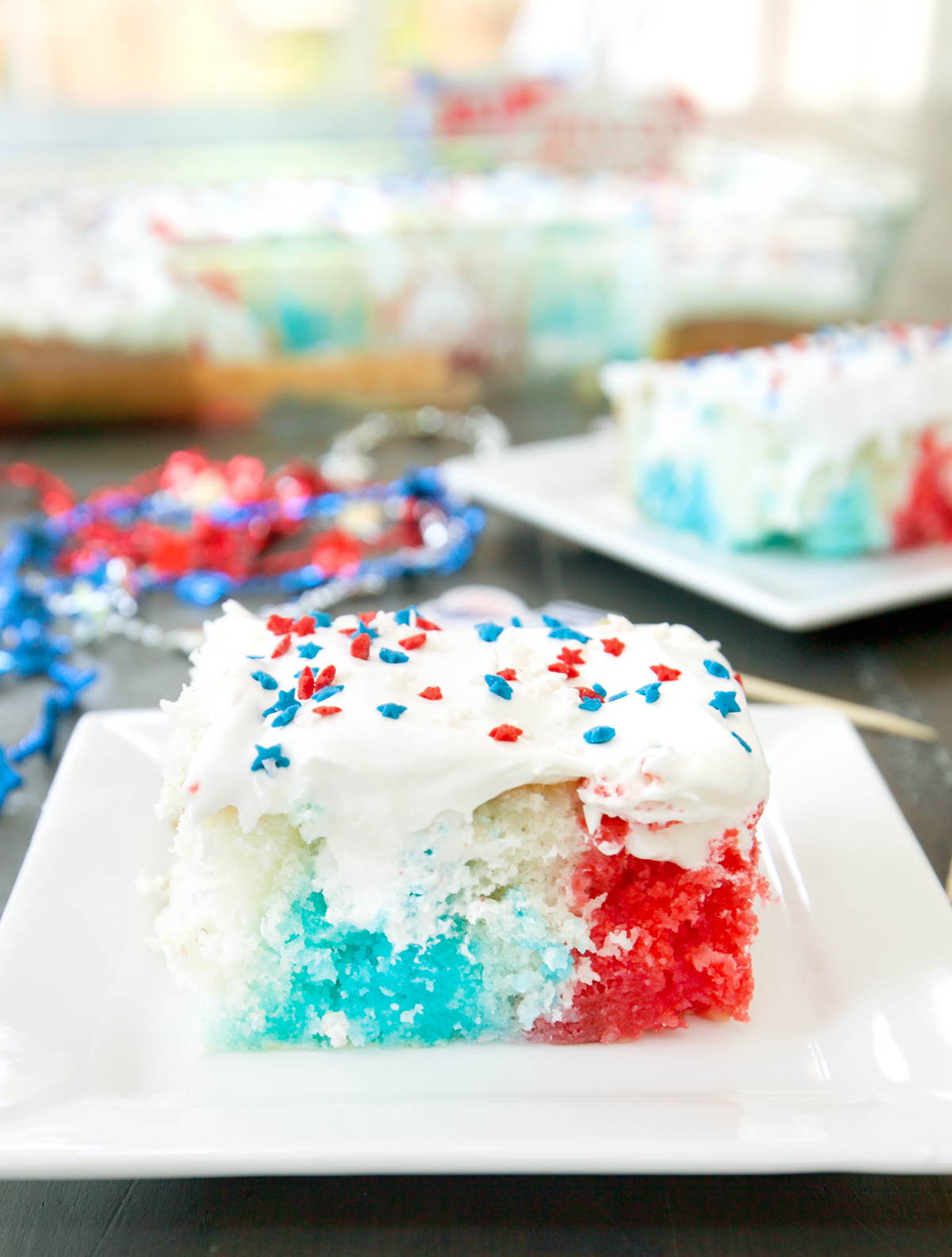 a single slice of red white and blue poke cake