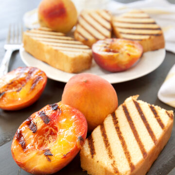 a big plate of grilled pound cake slices with grilled peaches