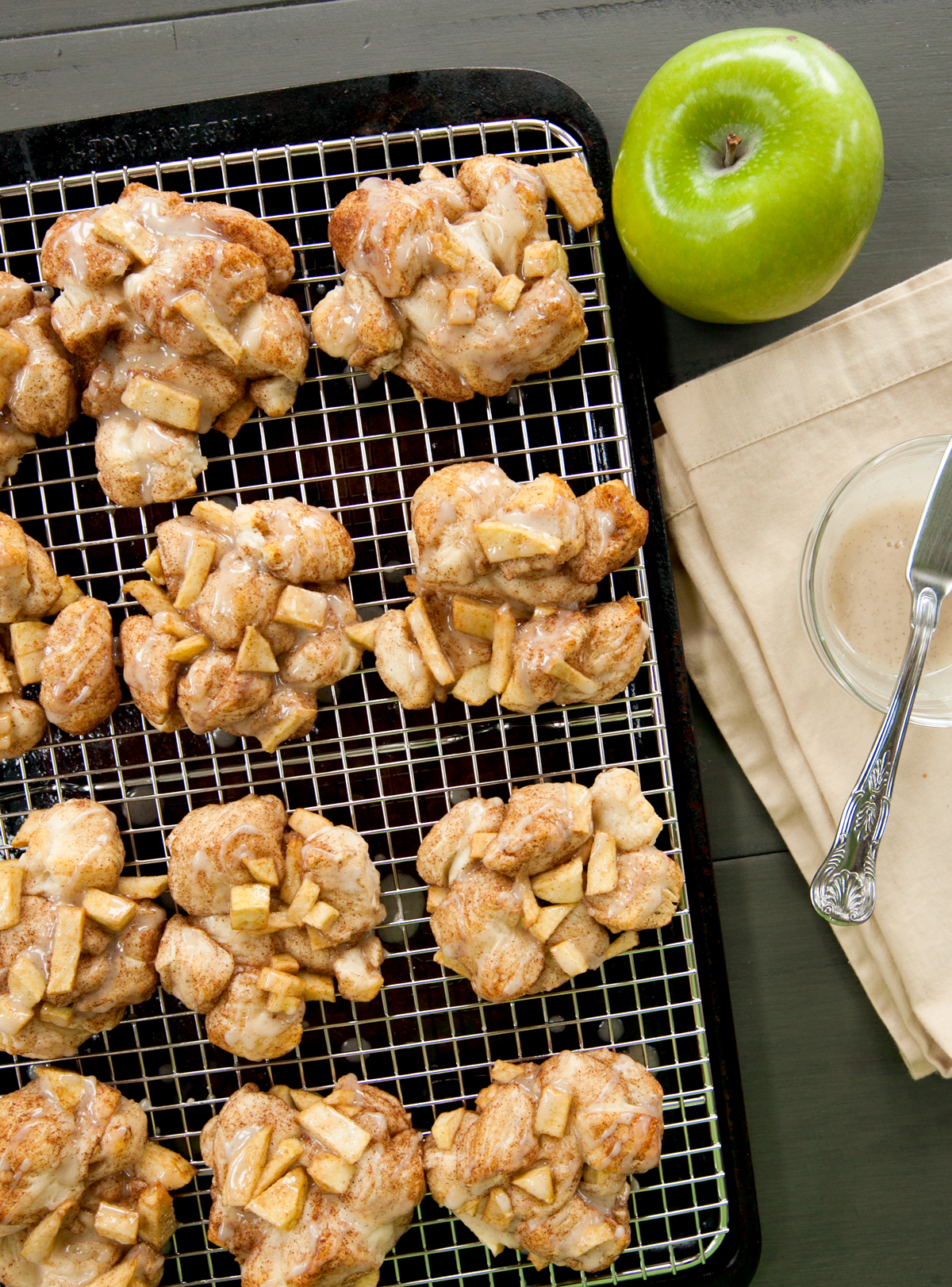 overhead view of baked apple fritters drizzled with vanilla glaze