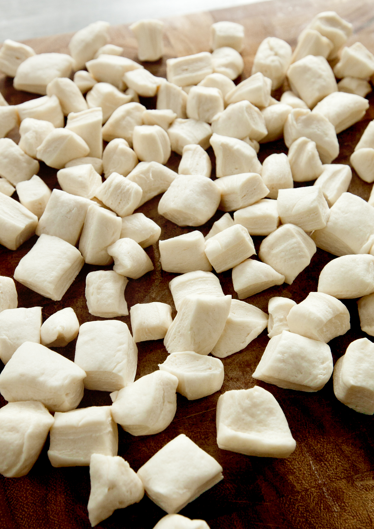 close up of canned biscuit dough chopped into pieces