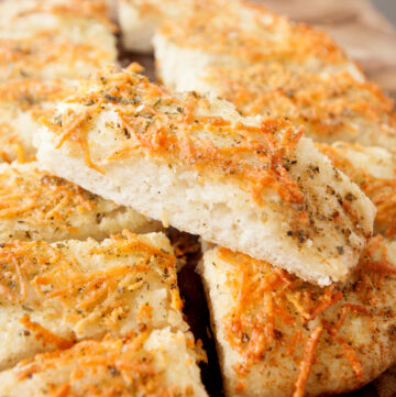 a chewy homemade breadstick sitting on other bread sticks