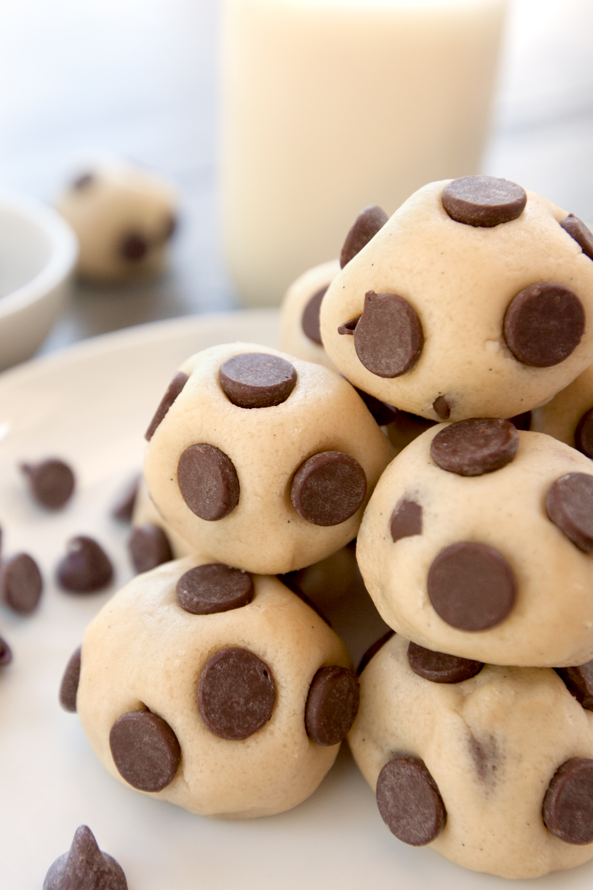 A close up of a pile of edible cookie dough bites with chocolate chips