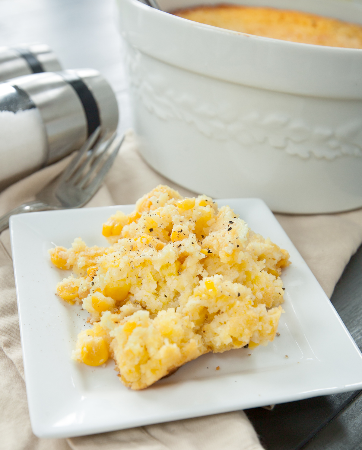 A creamy spooned out pile of cornbread casserole