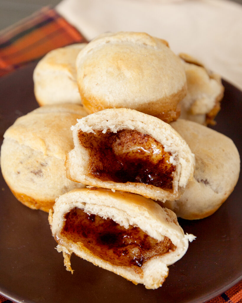 Hocus Pocus buns with one cut in two to reveal the empty cinnamon sugar center.