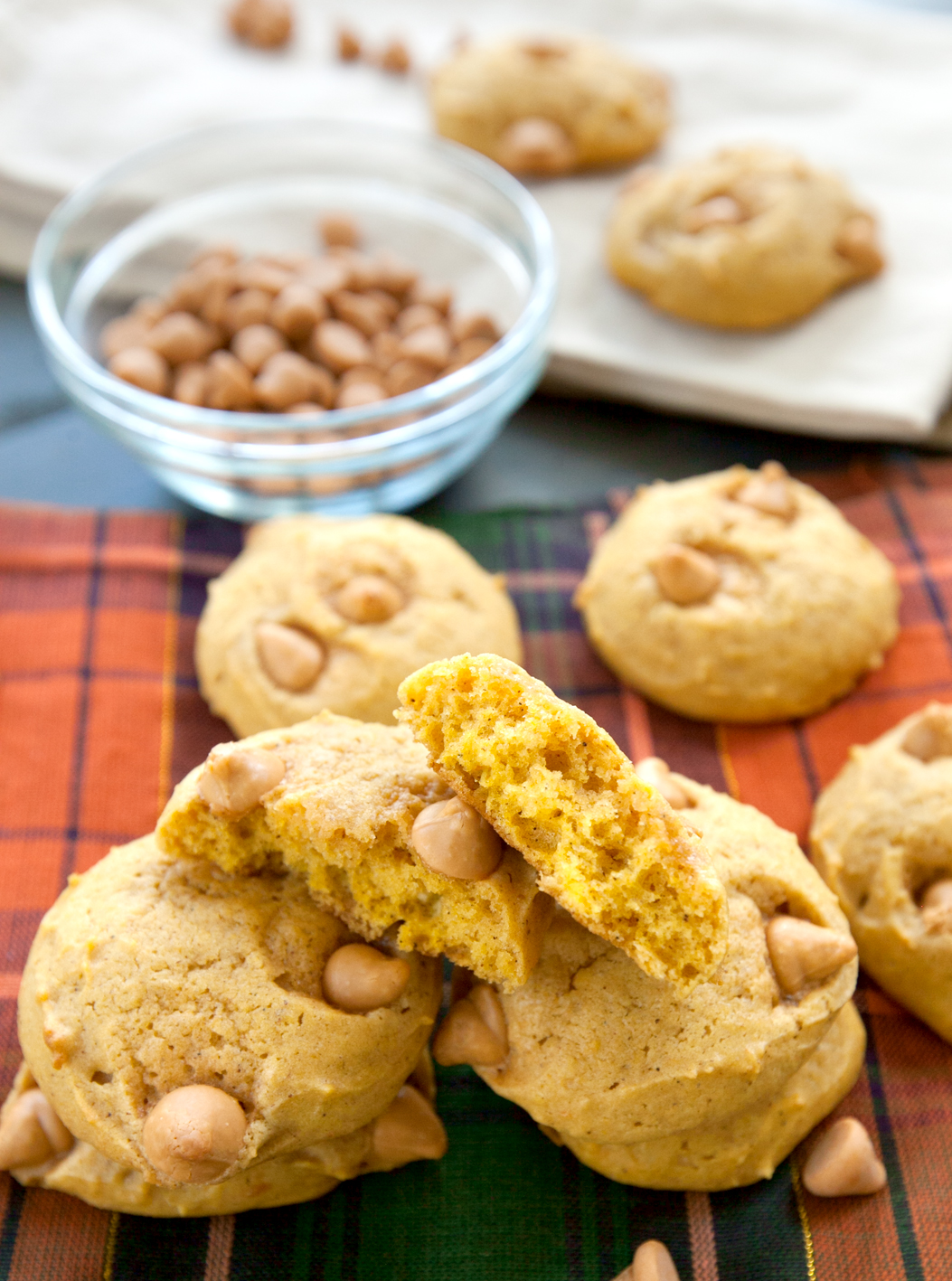 Pumpkin butterscotch cookies with one broken in half to see the soft cake-like texture inside.