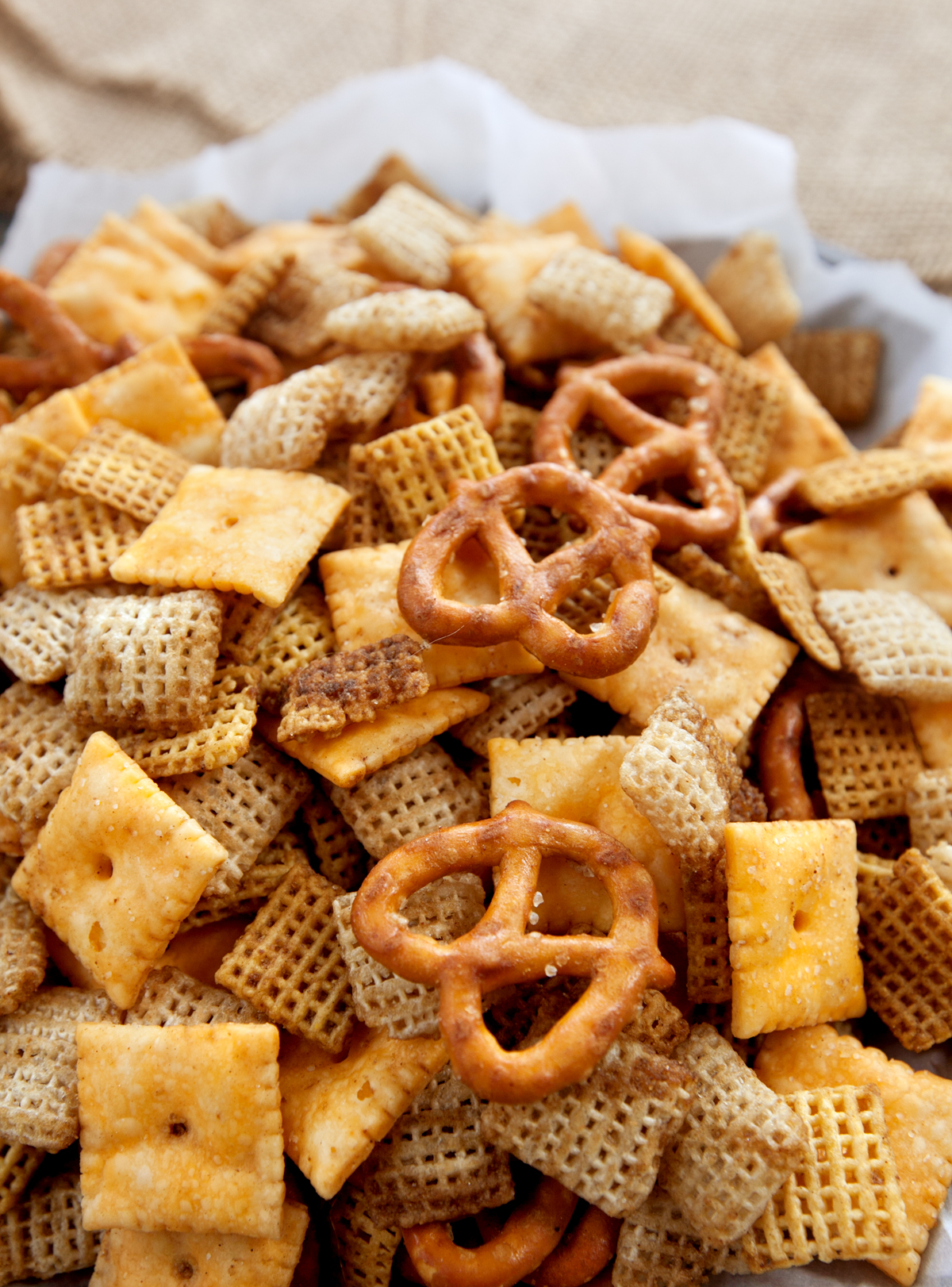 A very close up photo of a pile of bold chex mix