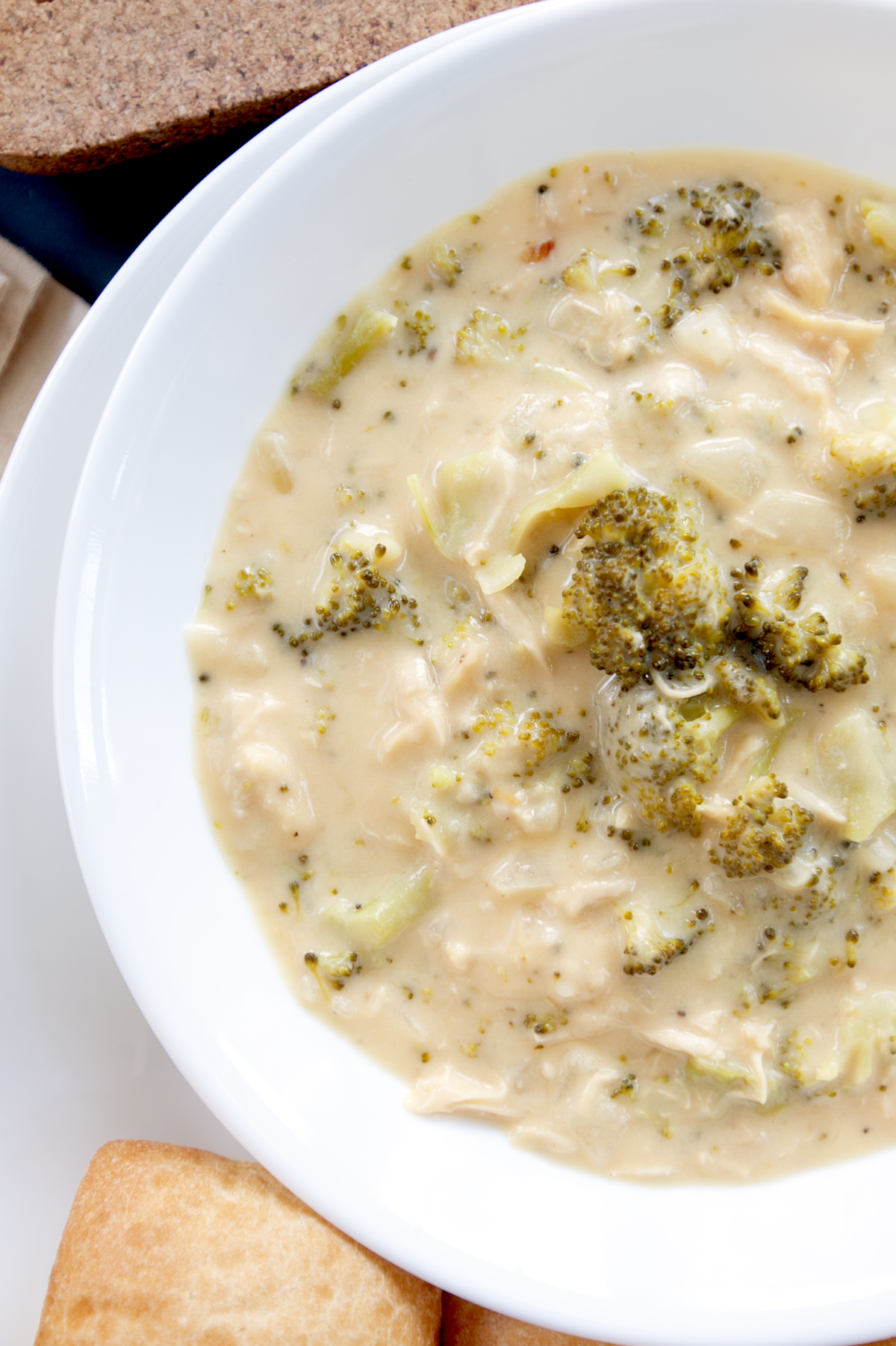 Close up of a bowl of thick chicken broccoli cheddar soup.