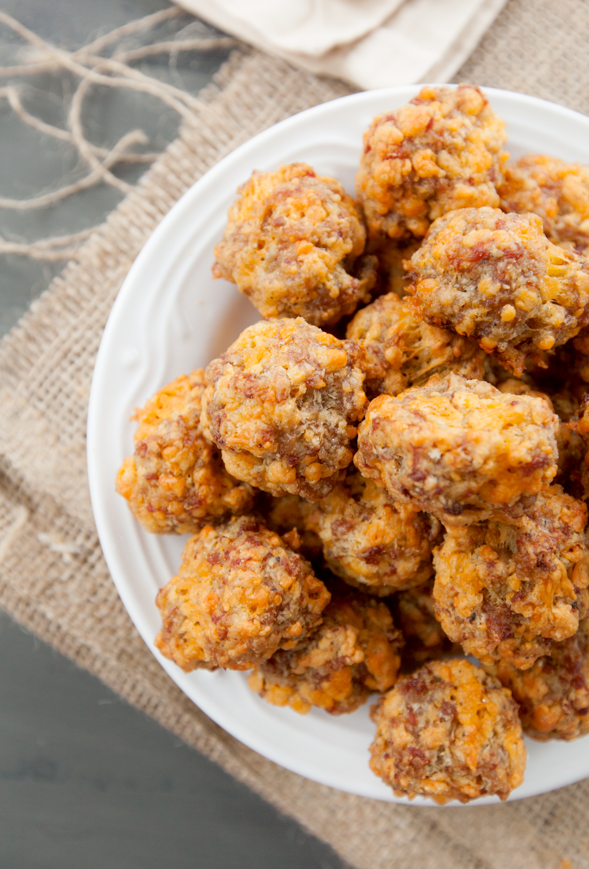 An overhead view of a plate of sausage balls made with sharp cheddar and without the use of Bisquick.