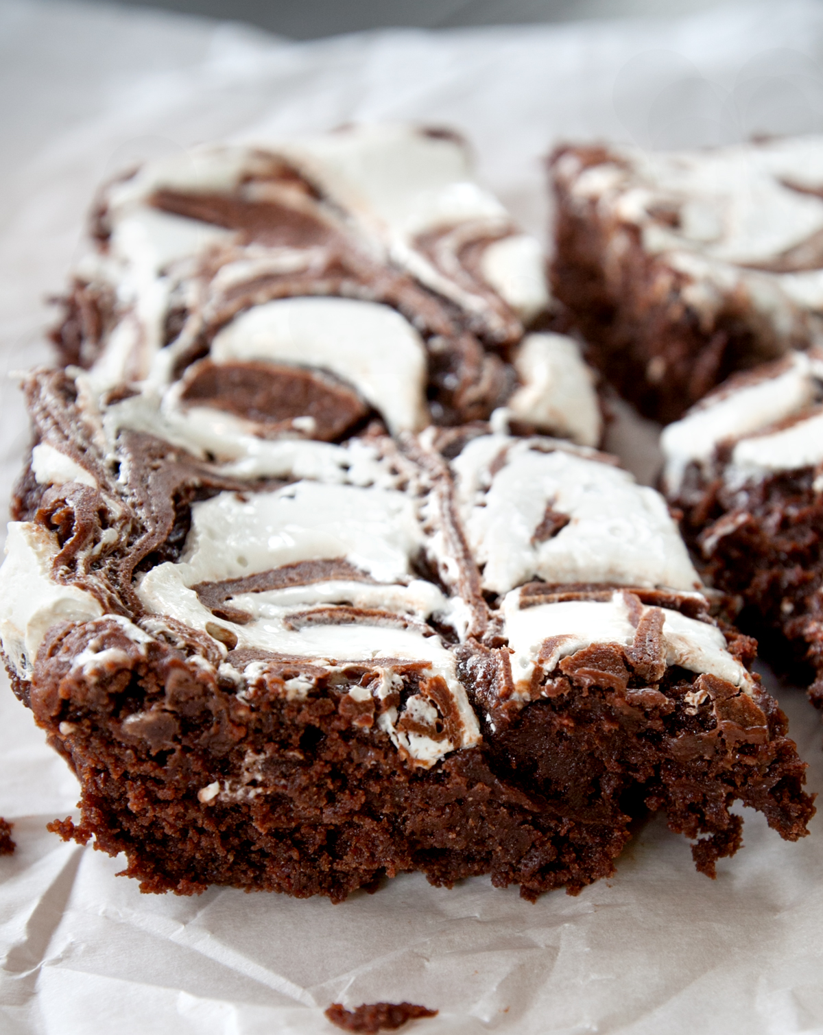 An up close photo of super ooey gooey brownies with marshmallow fluff.