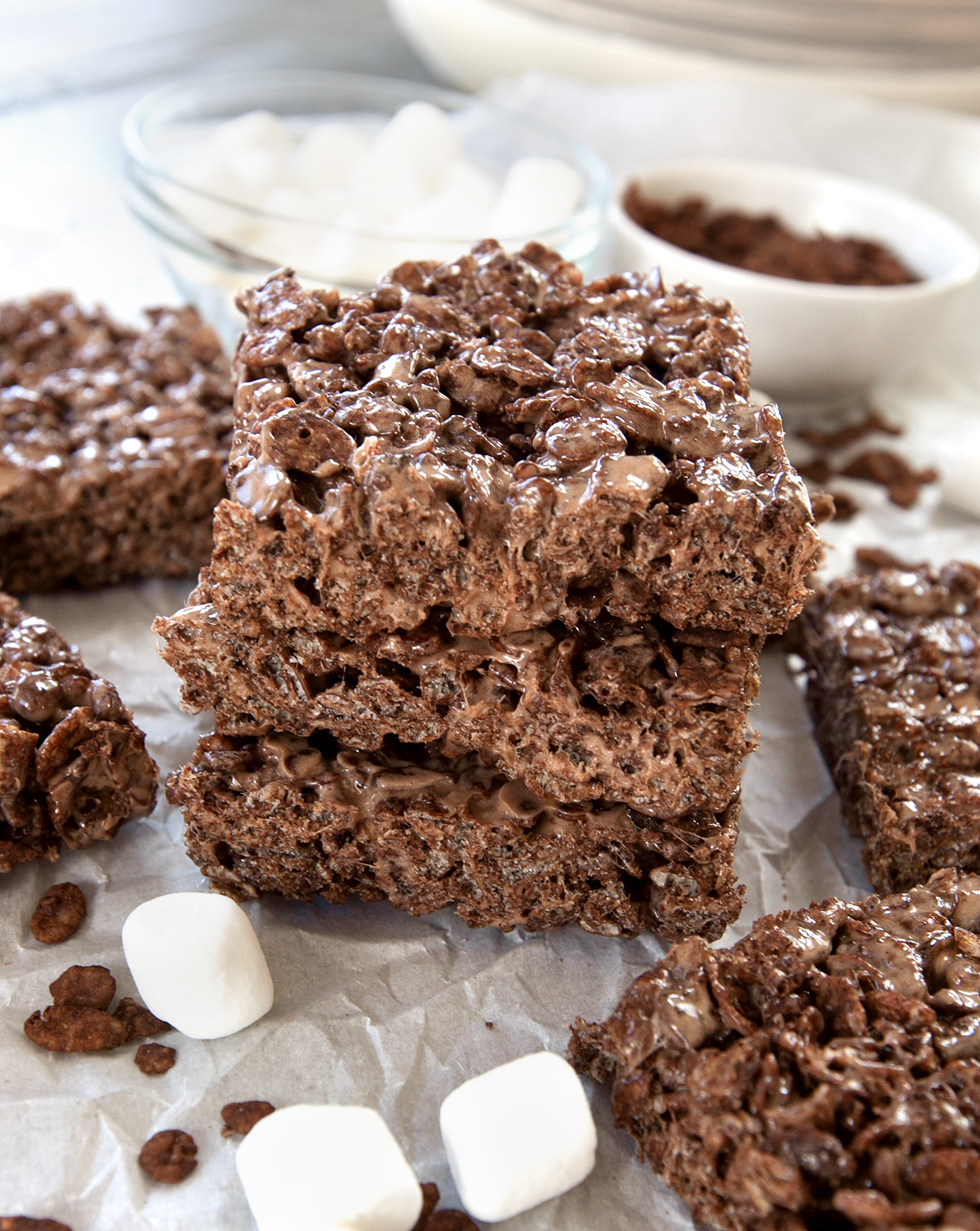 A stack of cocoa pebbles treats with marshmallows and cereal seen in the background.