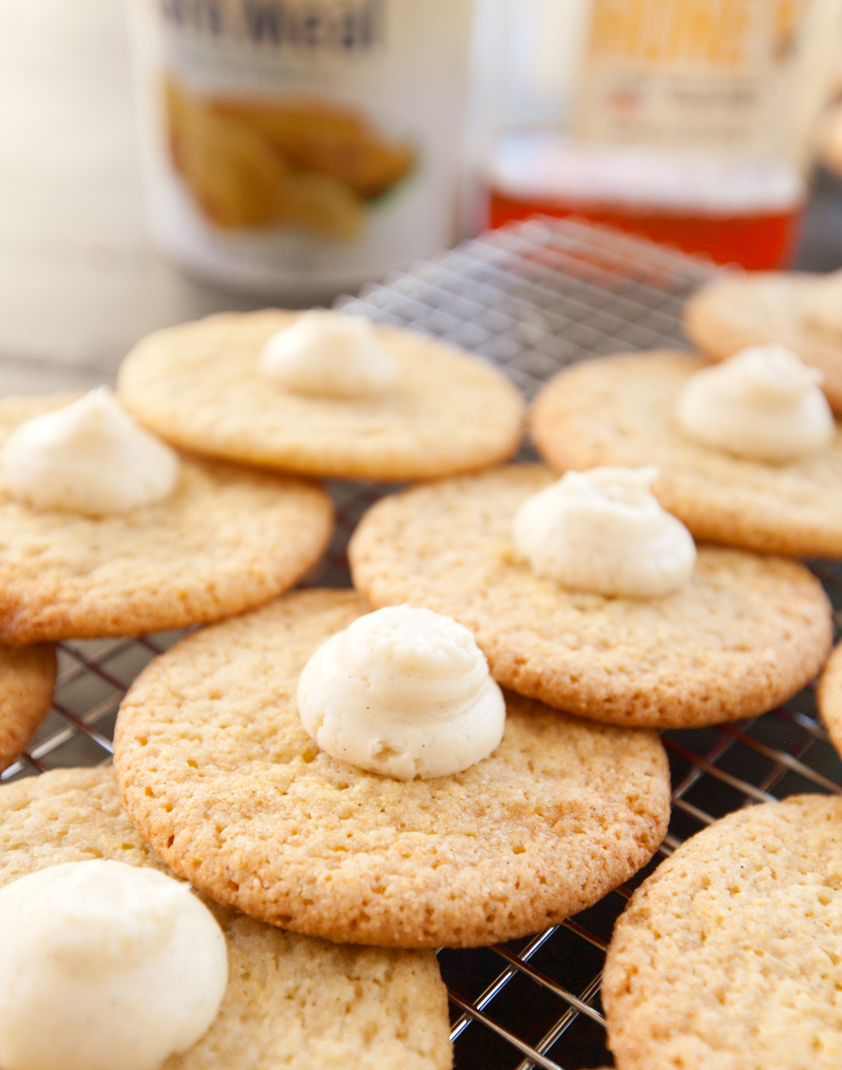 Rows of cornbread cookies with a dollop of sweet honey buttercream in the center.