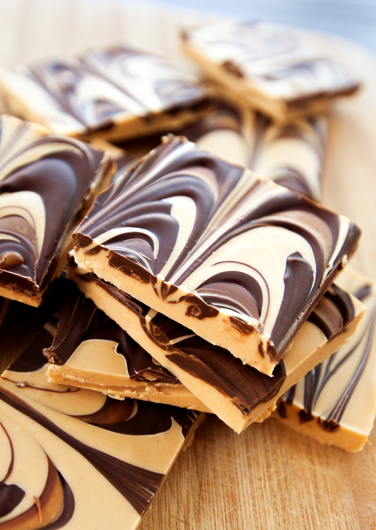 A stack of squares of tiger butter fudge with beautiful marbling visible.