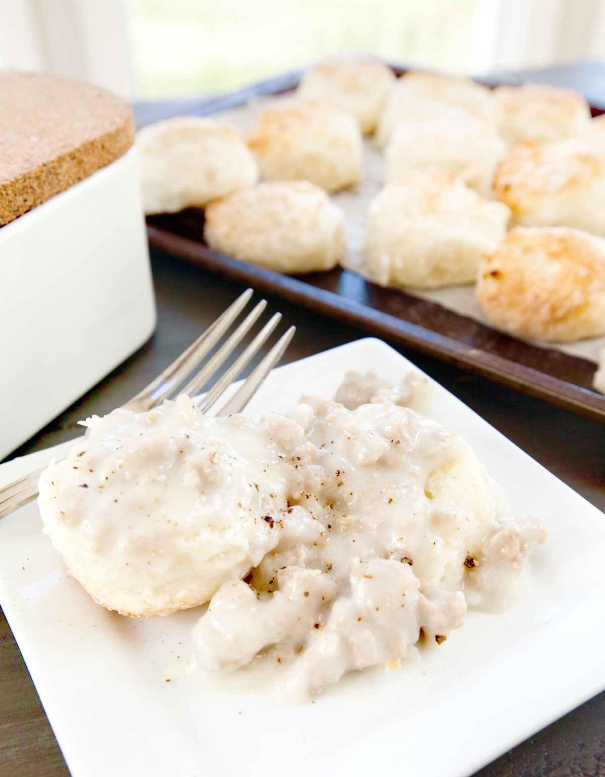 Up close plate of low calorie biscuits covered in turkey sausage gravy.