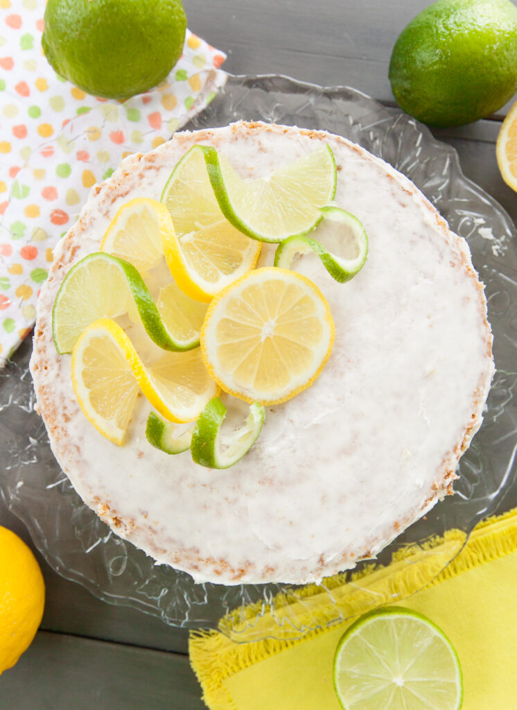 Overhead photo of a sprite cake garnished with lemon and lime slices and twists.