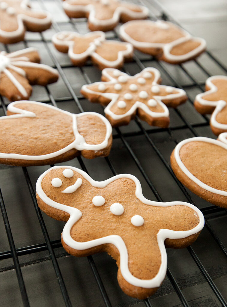 A rack of no chill gingerbread cookies decorated with white royal icing.