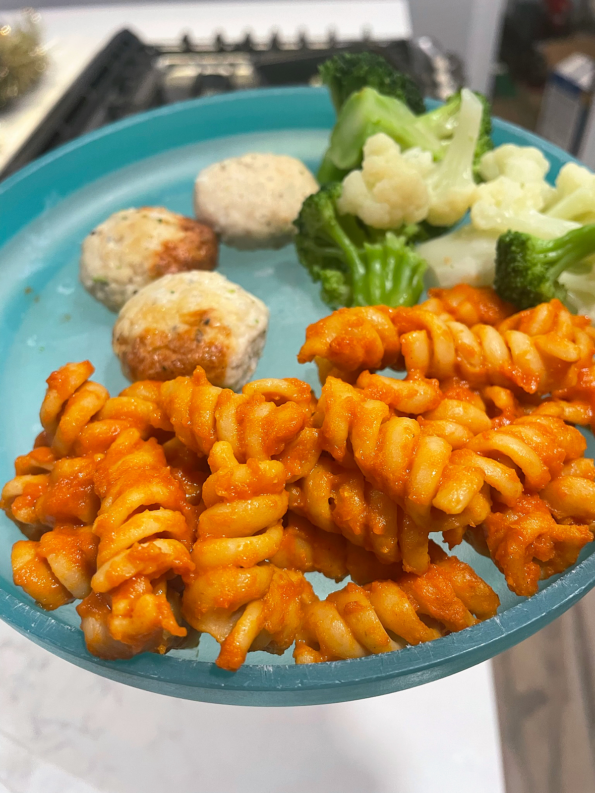 Plated Nurture Life chicken meatballs with spiral pasta meal.