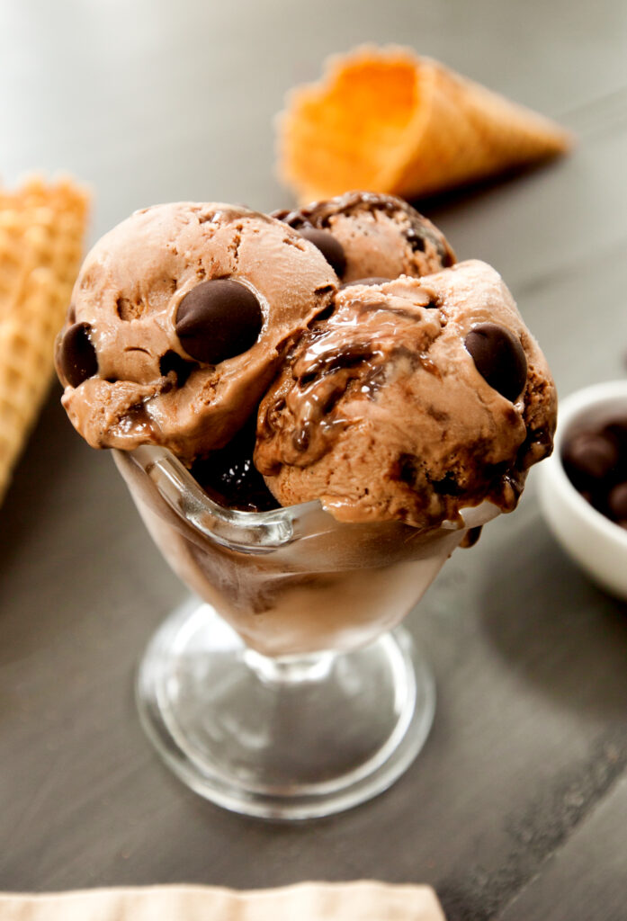 An old-fashioned ice cream dish of three scoops of triple chocolate ice cream.