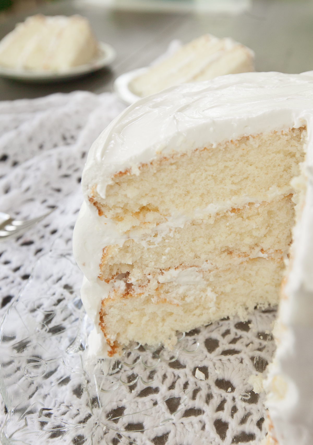 A close-up of the inside of Django white cake, showing the individual layers and frosting.