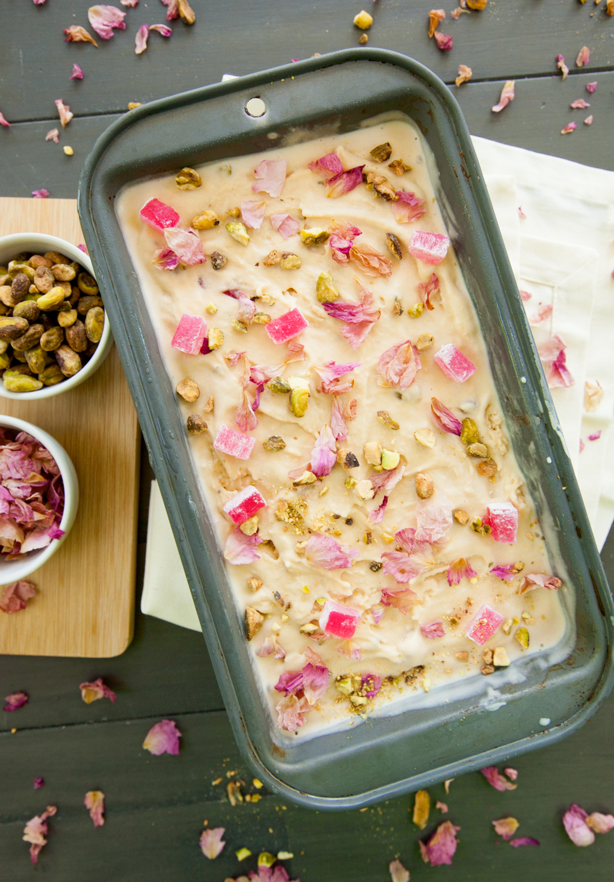 An overhead view of a metal container of homemade turkish delight ice cream with beautiful garnish.