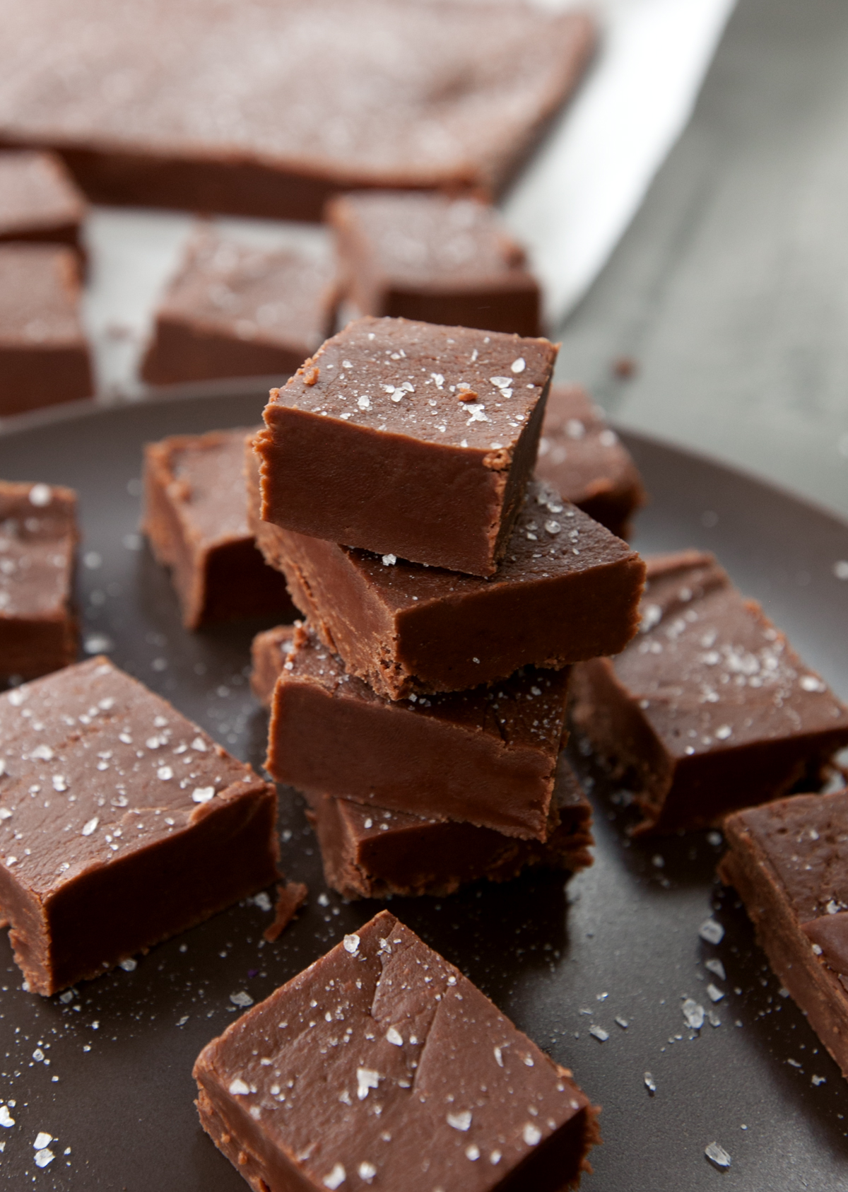 a stack of yummy dark chocolate fudge that has been topped with sea salt.